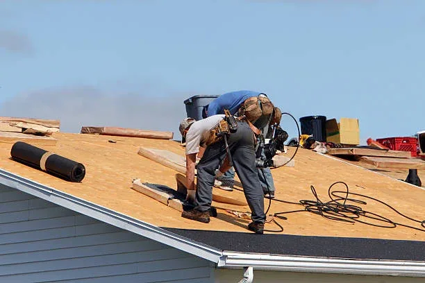 Roofing crew relaying underlay during a full roof restoration